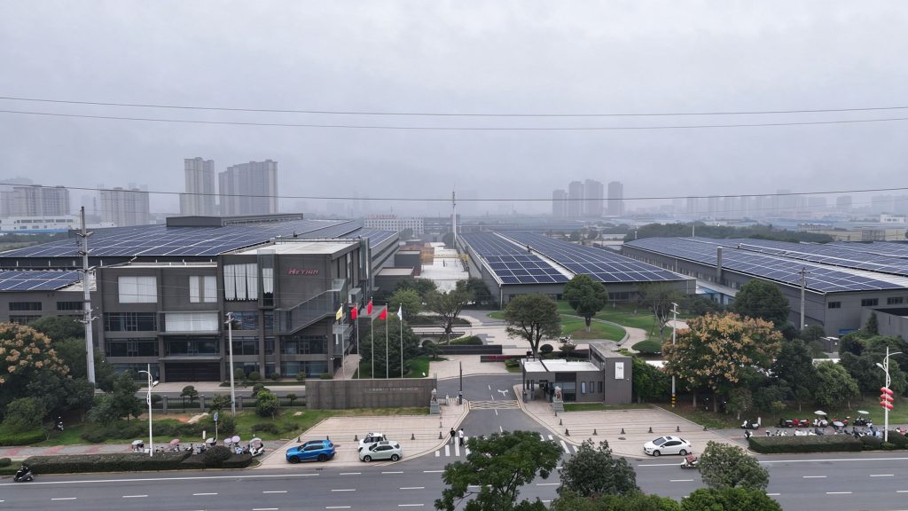 Aerial view of Hetian plant roofs covered with solar arrays (illustrative)