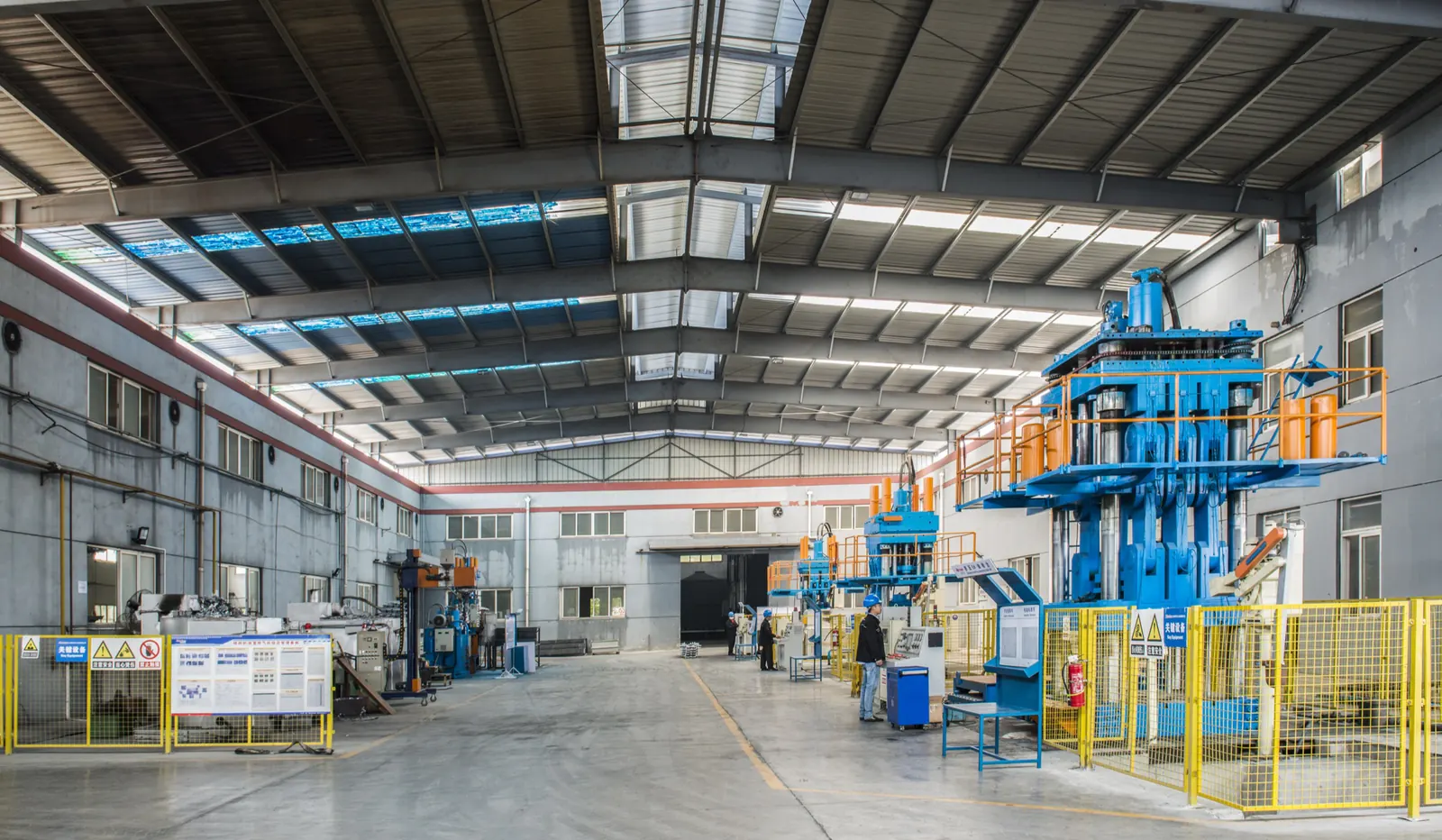 Die casting machines behind safety fencing at the Hetian Wuhu plant